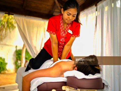 Massage therapist doing a massage in a client